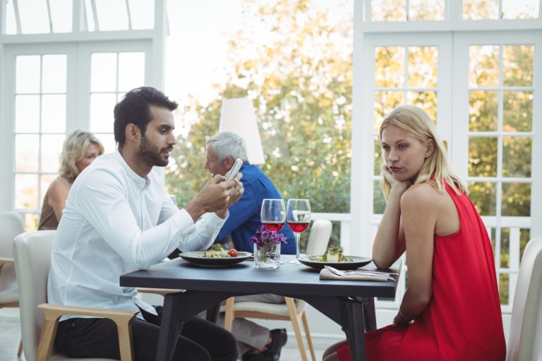 Man ignoring bored woman